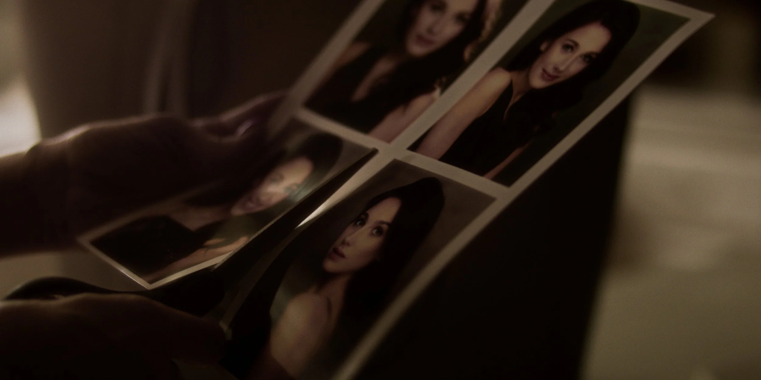 Person holding a photo strip with four pictures of a woman in different poses