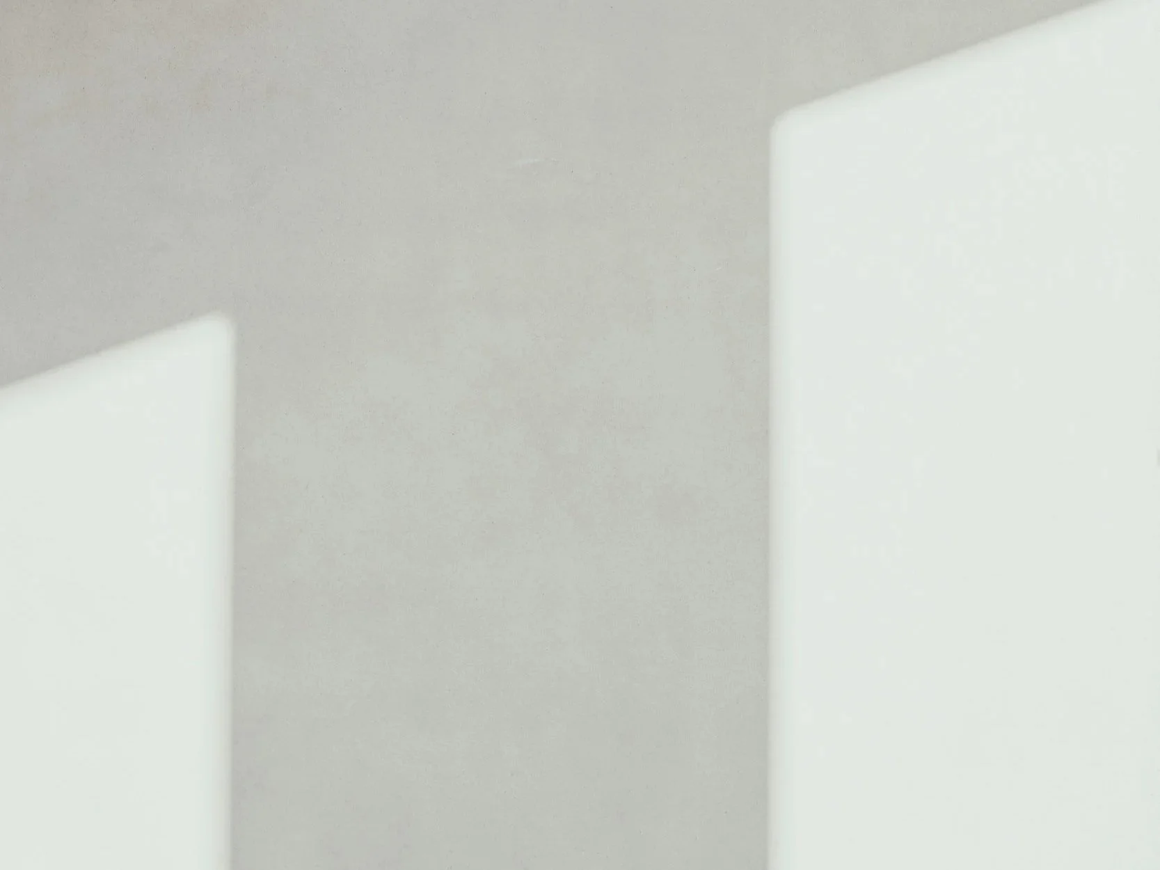 Close-up of white walls and ceiling with minimalistic modern design.