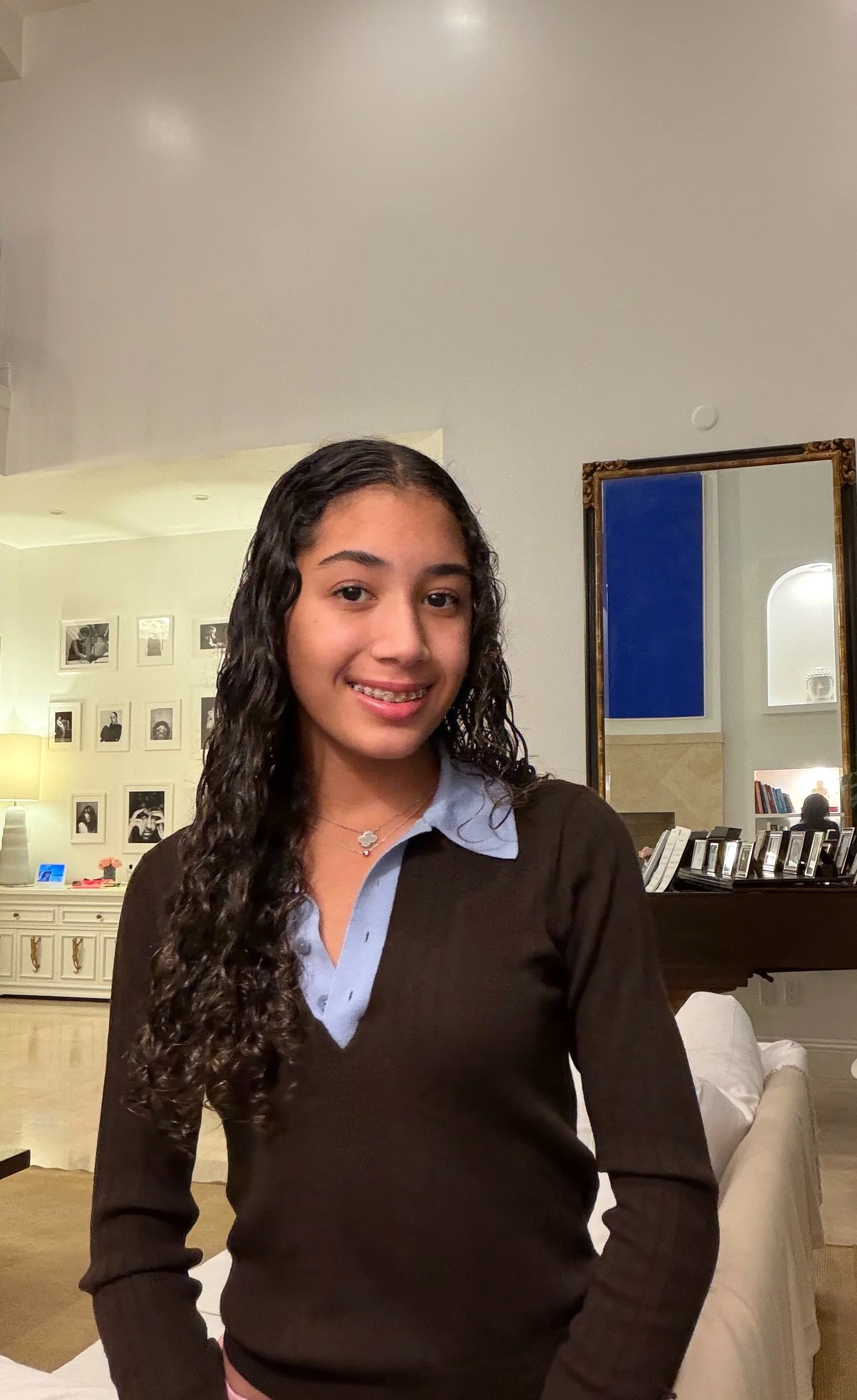 Alessandra Boucher, founder of Thread by Thread, smiling in a brown sweater and blue collared shirt