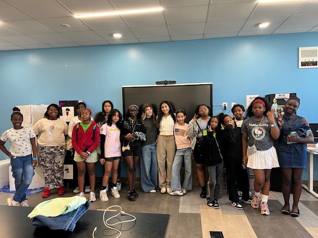 Large group of girls posing together after completing a Thread by Thread upcycling workshop