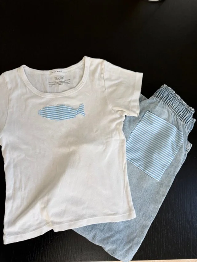 Children's white t-shirt and light blue shorts upcycled with a striped blue fish appliqué and matching pocket patch