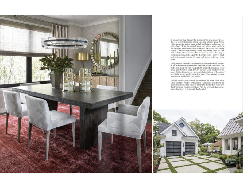 Interior of a dining room with a dark wooden table, four white upholstered chairs, a red patterned rug, and a large window with light-colored curtains. Walls are light gray with textured wallpaper, a round mirror, a gold wall decoration, and a sidebo
