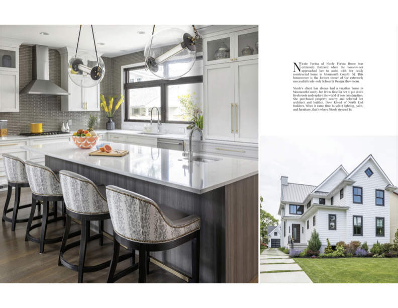 Modern kitchen with white cabinets, marble island, pendant lights, and a view of a white house with a landscaped yard