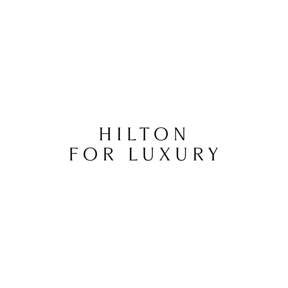 Black and white Hilton logo with text 'Hilton for Luxury' at the bottom