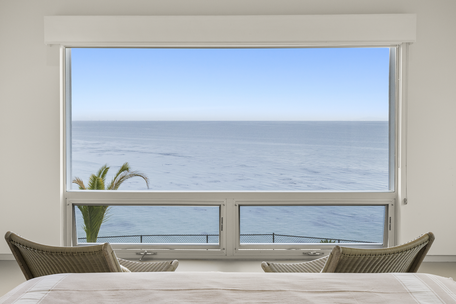 Ocean view through a bedroom window at Shoreline House