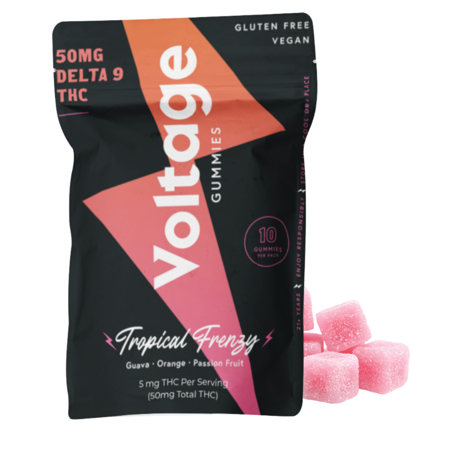 A black and pink bag of Voila! THC Gummies labeled 'Tropical Frenzy' with guava, orange, and passion fruit flavors, containing ten gummies, each with 5 mg of THC, and some pink sugar-coated gummies next to the bag.