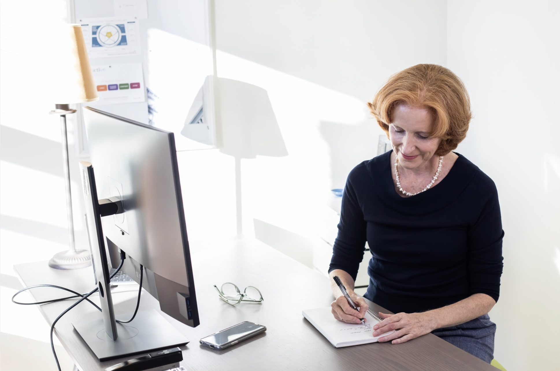 Certified coach Rachel Simeone writing answers to frequently asked questions about leadership coaching