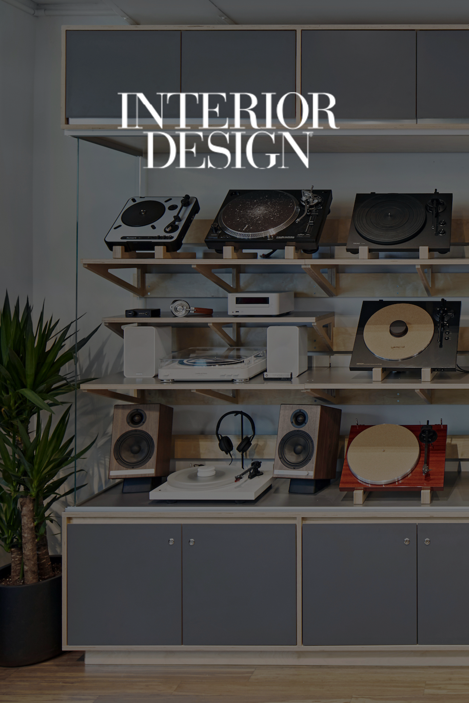 Cover photo of Interior Design magazine featuring a retail interior with vintage and modern turntables on wooden shelves, a potted plant on the left and gray cabinets at the bottom.
