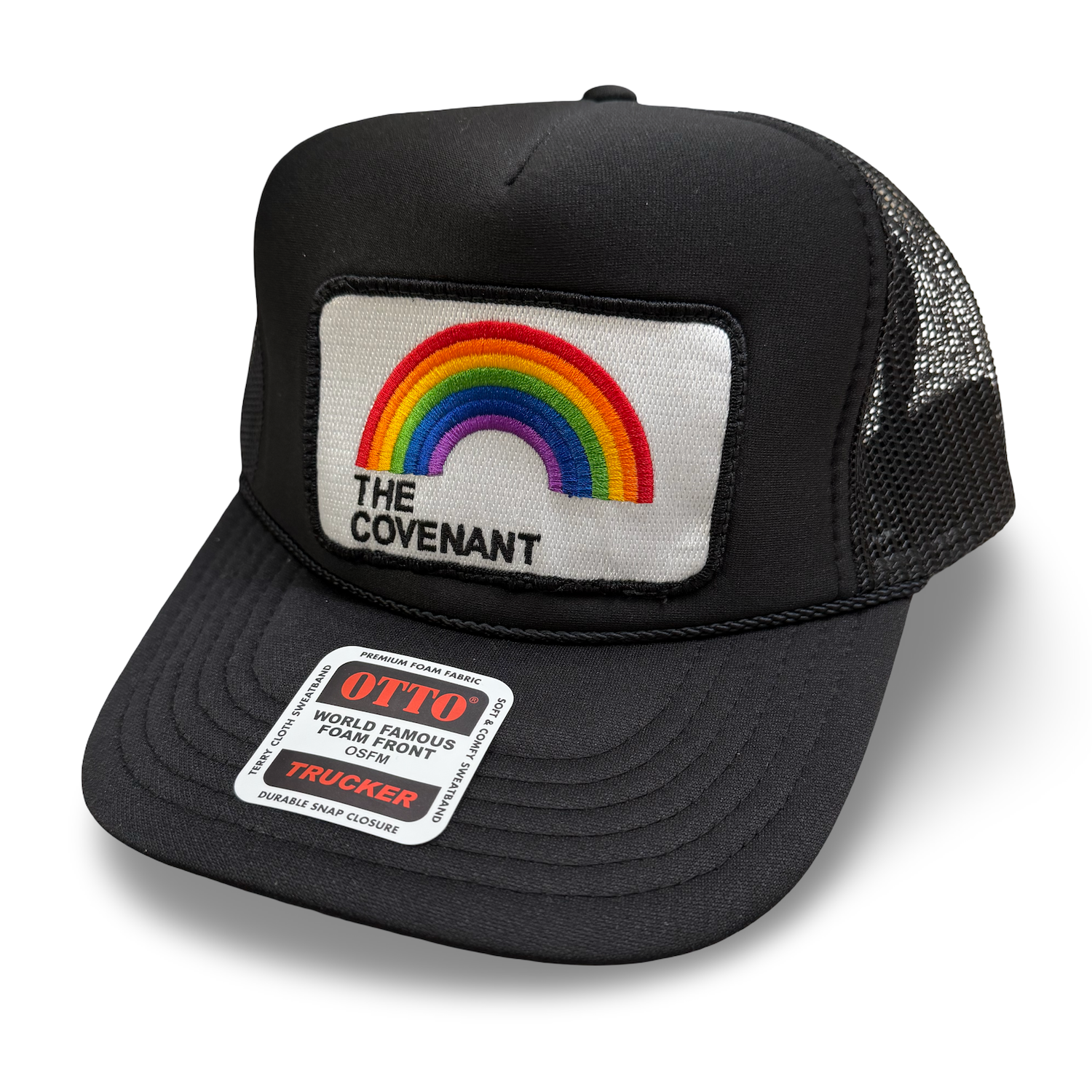 Black trucker cap with rainbow patch and the words 'The Covenant' on the front, mesh side panels, and a sticker on the brim that says 'OTTO World Famous Foam Front Trucker'.