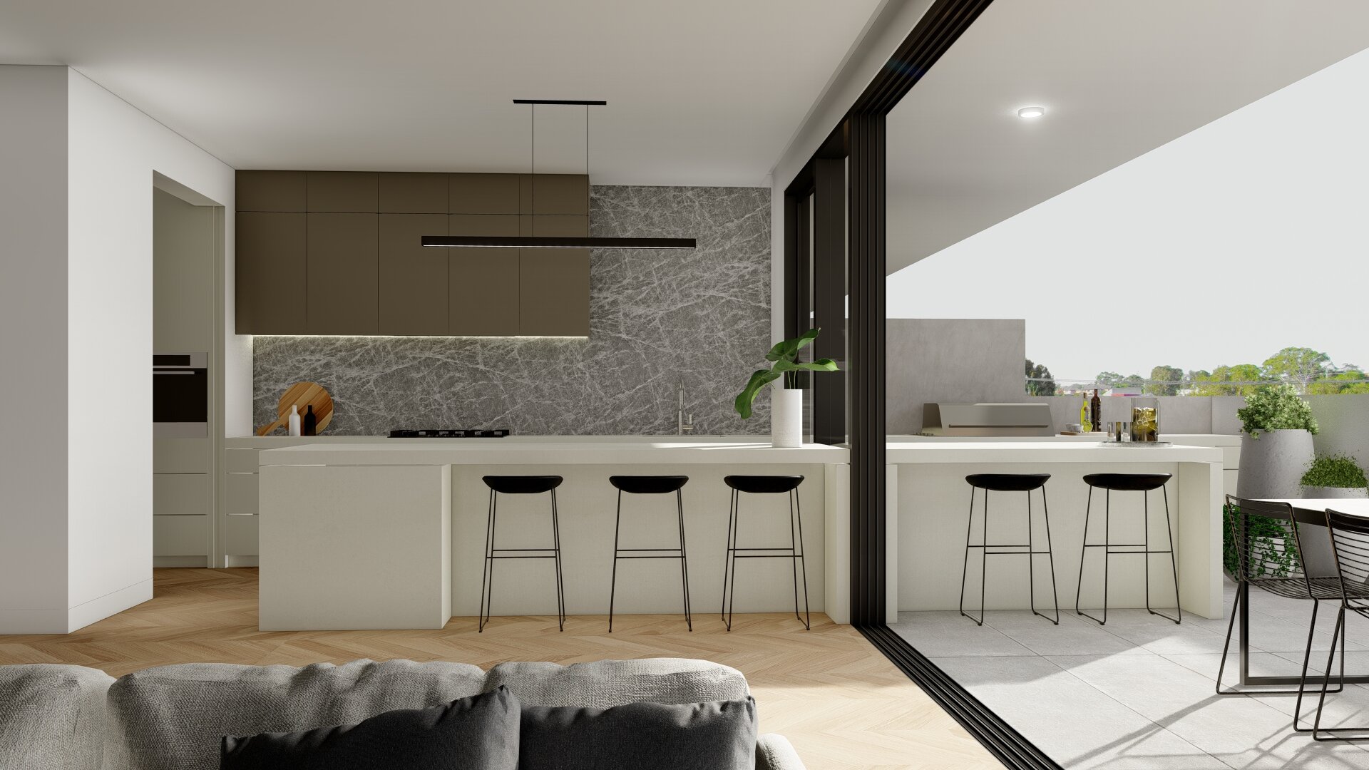 Modern open-concept kitchen with white island, black bar stools, gray and brown cabinetry, marble backsplash, and large sliding doors leading to a balcony with outdoor seating.
