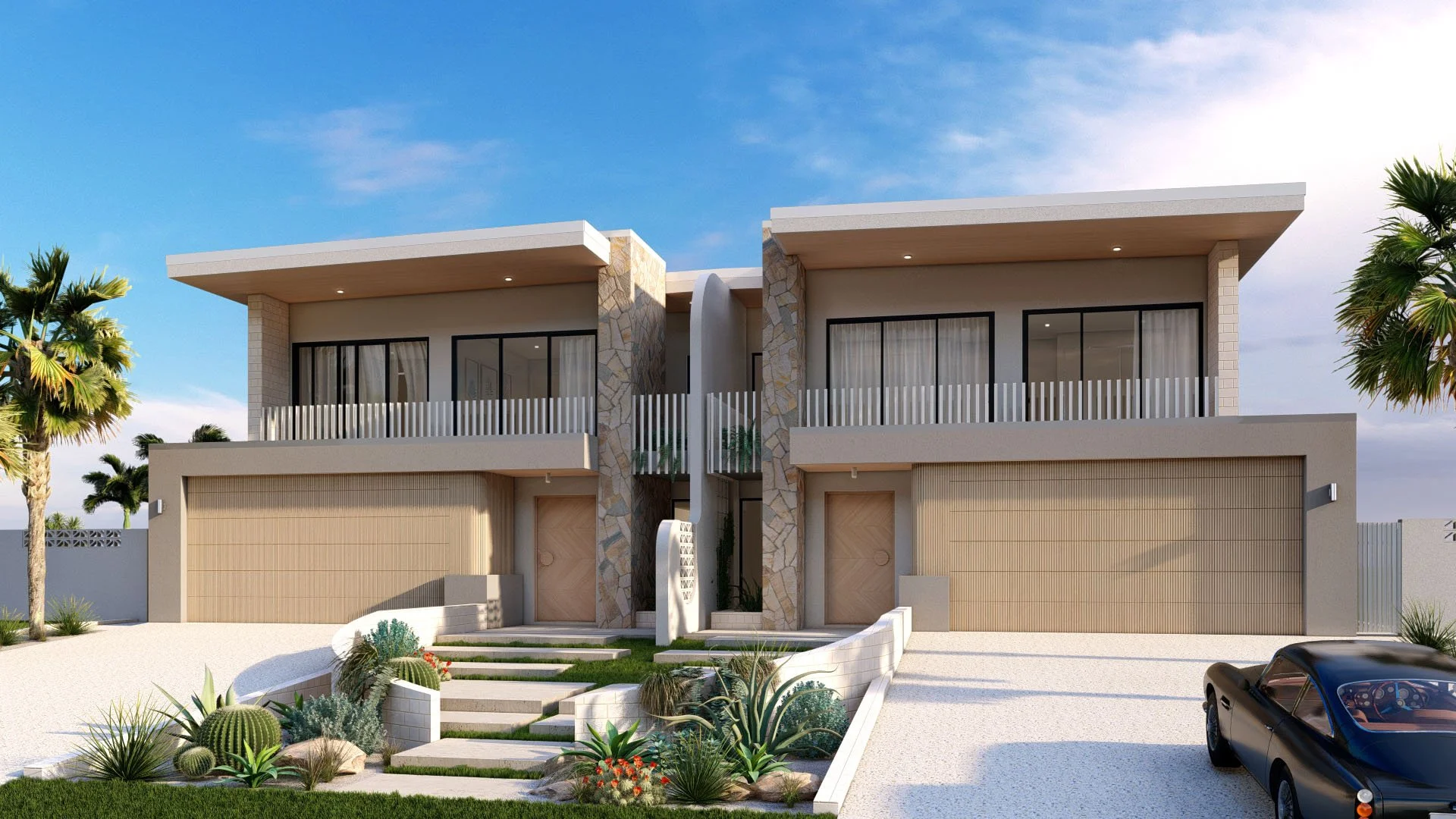 Modern duplex houses with beige walls, large glass windows, sliding doors, balconies with white railings, stone accents, front yard with desert plants, a black car parked on a white gravel driveway, and palm trees against a blue sky.