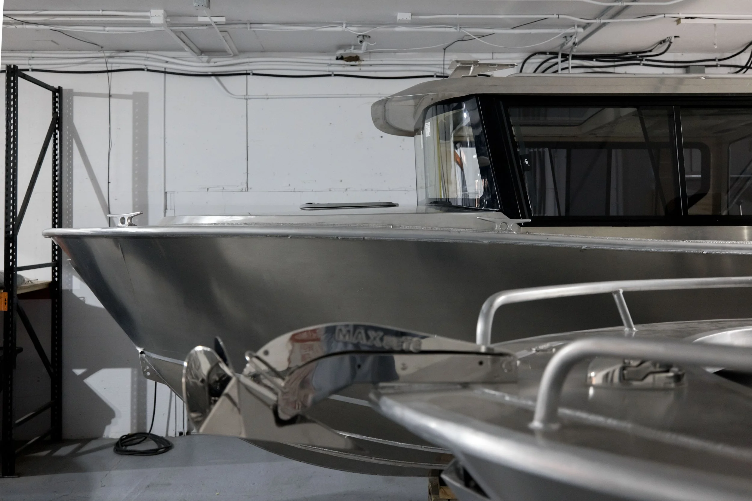 A large, metallic boat inside the Jasper Marine warehouse.