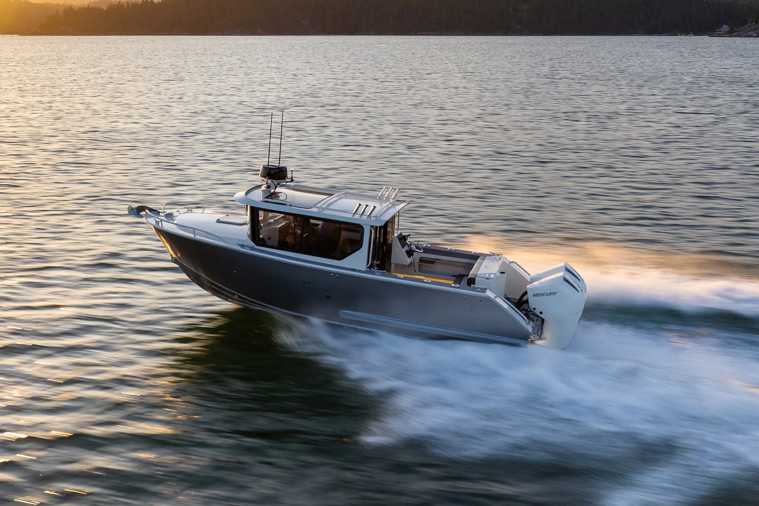 A Jasper Marine Defender 22 cruising swiftly on a calm body of water during sunset.