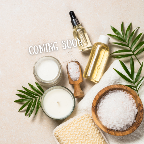 Spa and relaxation products including candles, essential oil dropper bottle, facial oil, coarse salt in a wooden bowl, and a towel with green palm leaves on a beige background.