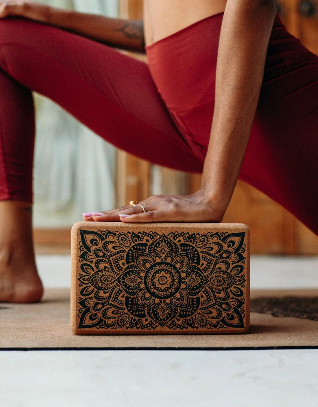 Woman in yoga pose with Cork Yoga Block in Mandala Black by Yoga Design Lab