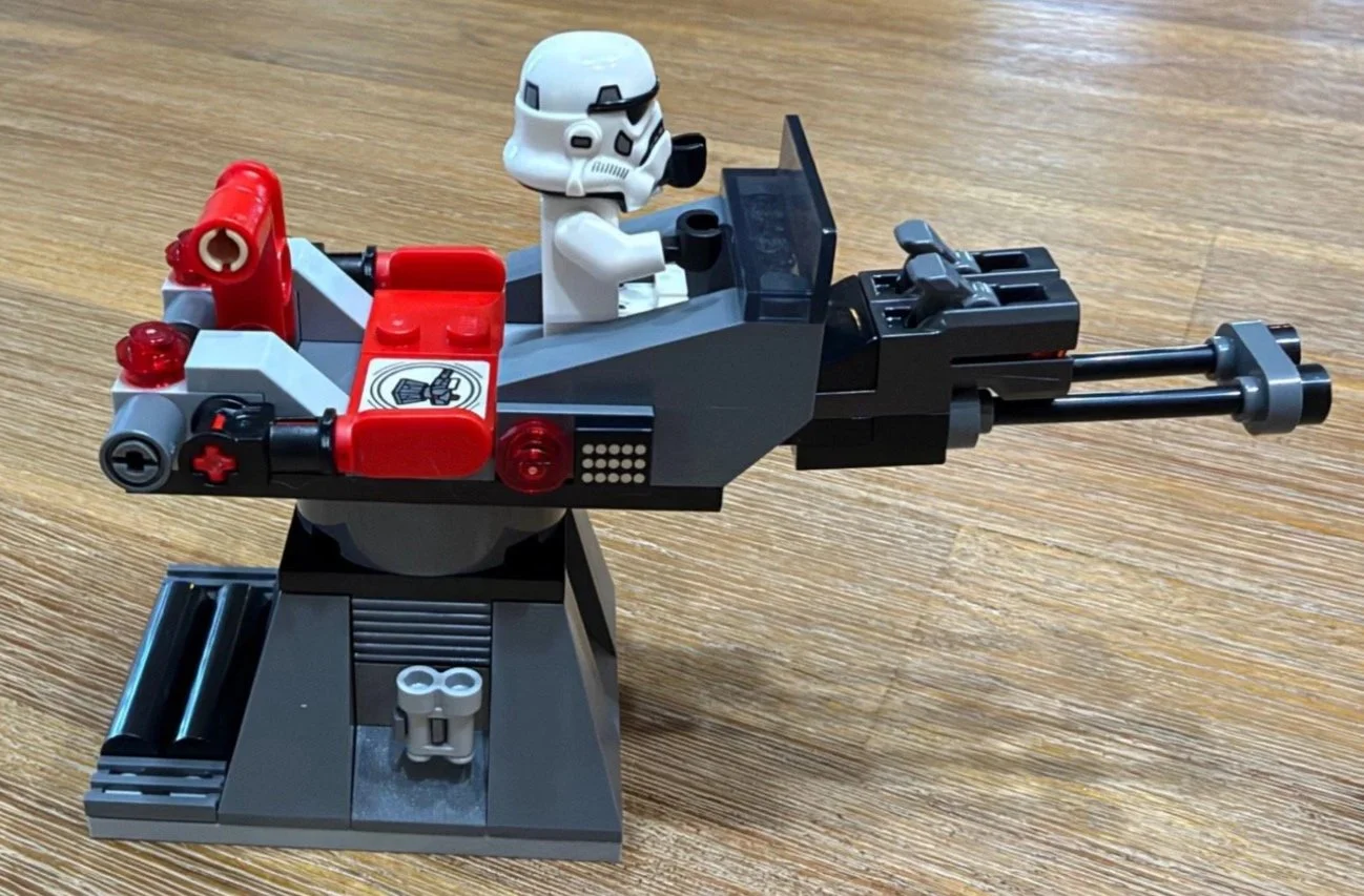 Imperial turret on a dark gray pedestal with a stormtrooper, twin barrels and exposed red SMART Tag in LEGO 75423.