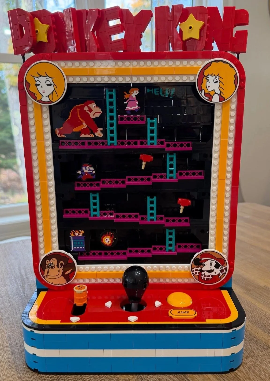 Completed LEGO Donkey Kong Arcade 72051 with red title letters, magenta ramps, turquoise ladders and a red control deck.
