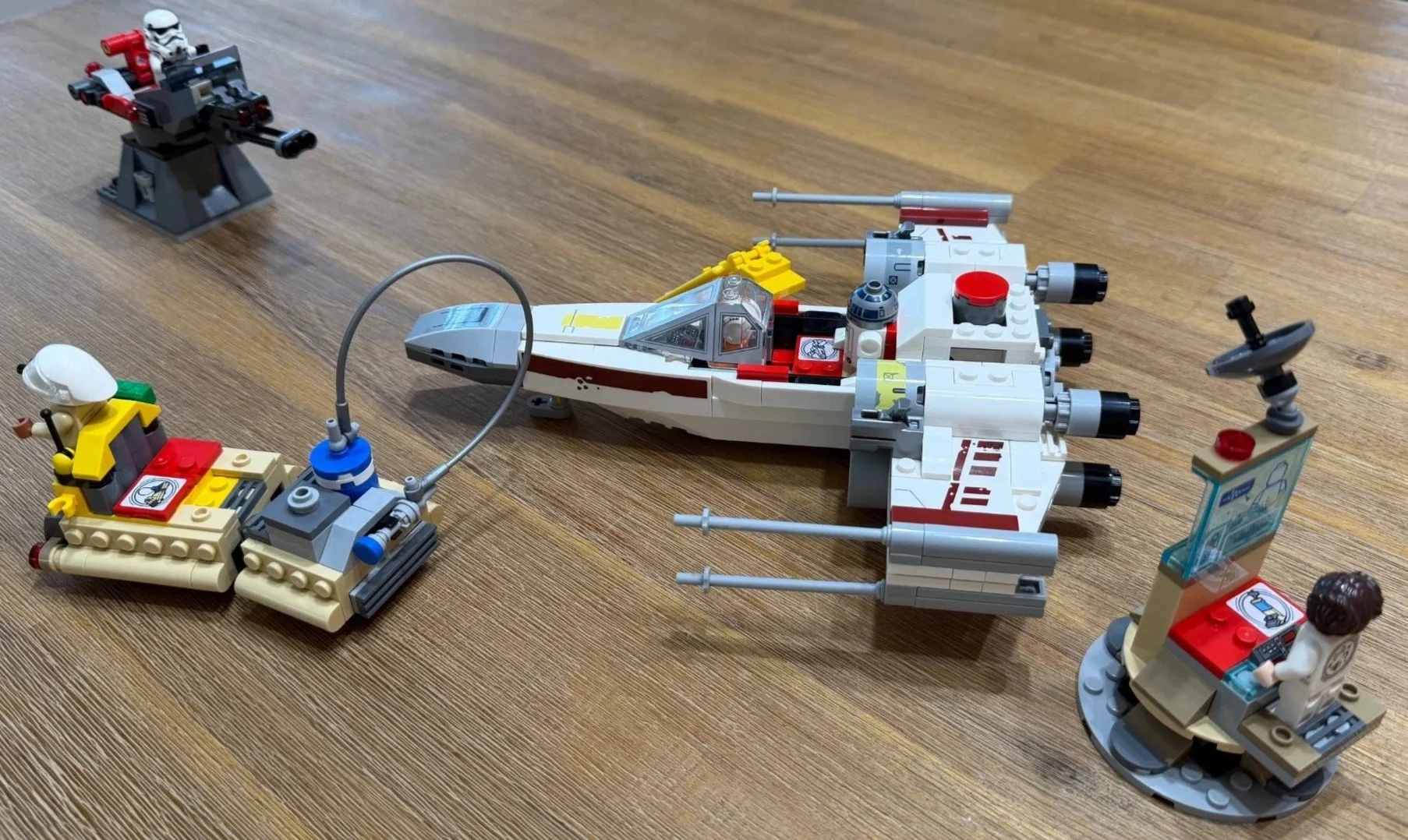 Completed LEGO 75423 scene with X-wing centered, fuel transporter at left, Imperial turret behind and Leia’s command center at right.
