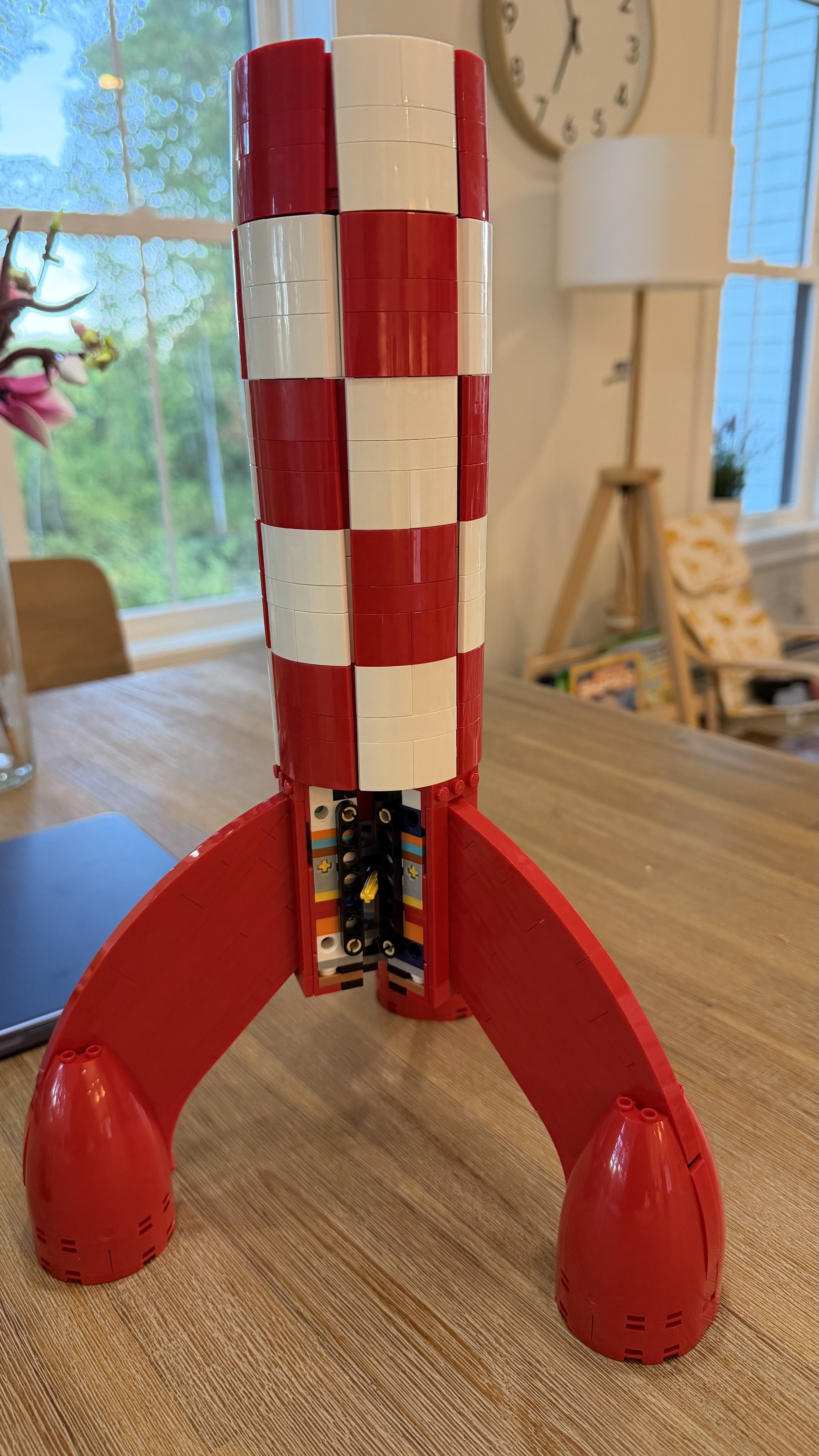 Partially completed LEGO Tintin Moon Rocket with landing gear and red and white exterior shell