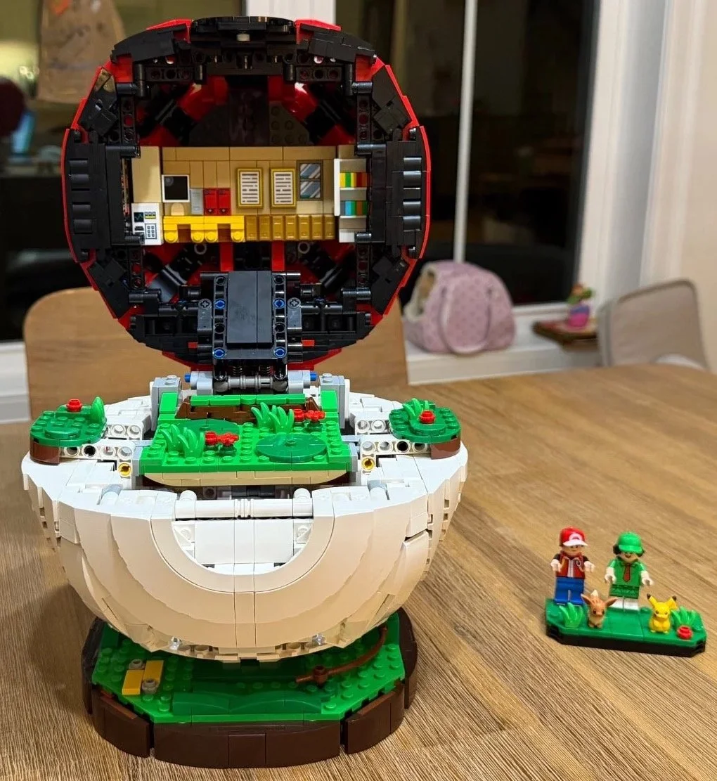 Open LEGO Poké Ball showing the laboratory and battle platform before the final display details are placed.
