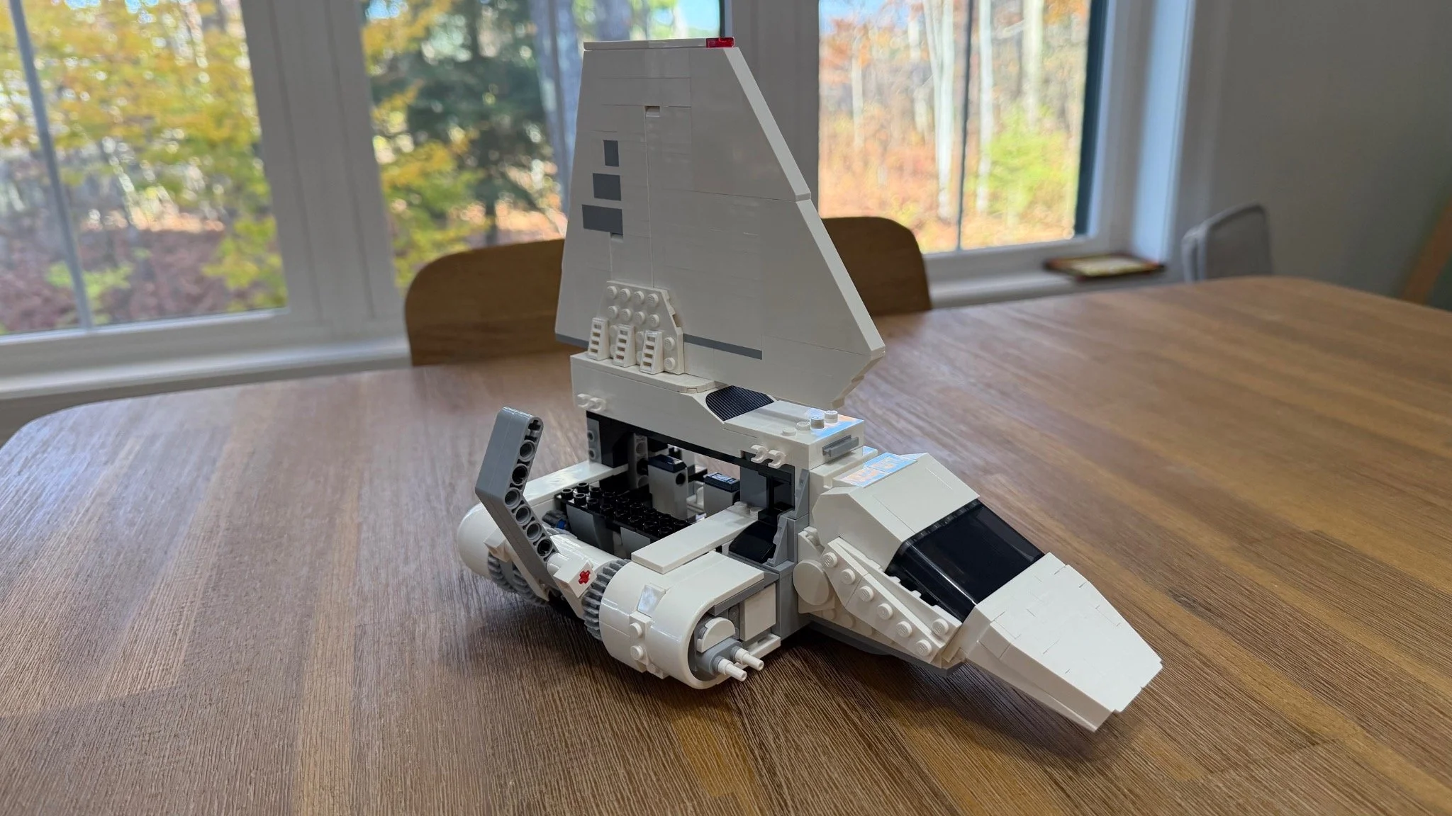 Angled view of the shuttle with one rounded wing-root assembly, exposed gears and an upright gray liftarm.