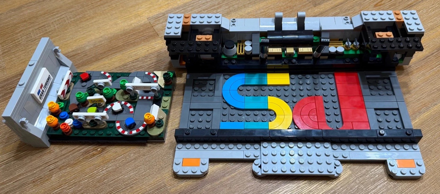 Partly built LEGO PlayStation with a taller rear wall and small internal component details.