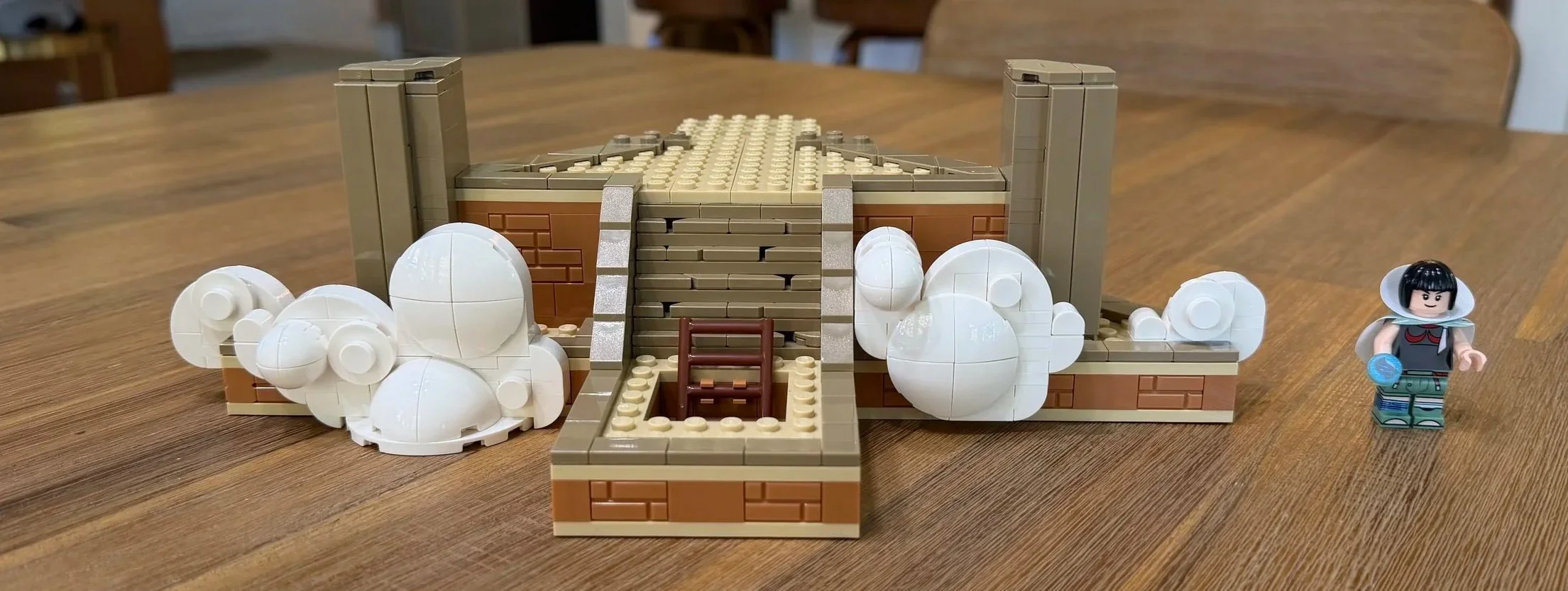 White brick-built clouds around the Sky Pillar base, with corner pillars and central tan stairs.