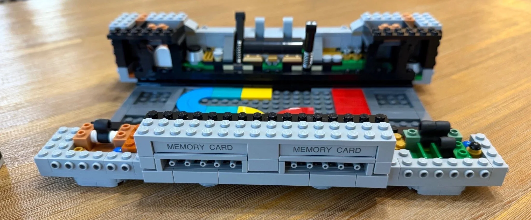 Close view of LEGO PlayStation controller ports beneath printed memory-card labels.