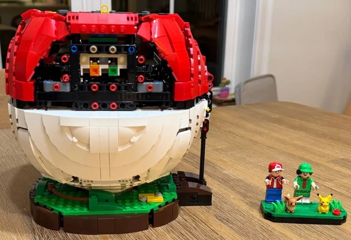 Red curved upper-shell sections on the LEGO Poké Ball as the exterior takes shape.