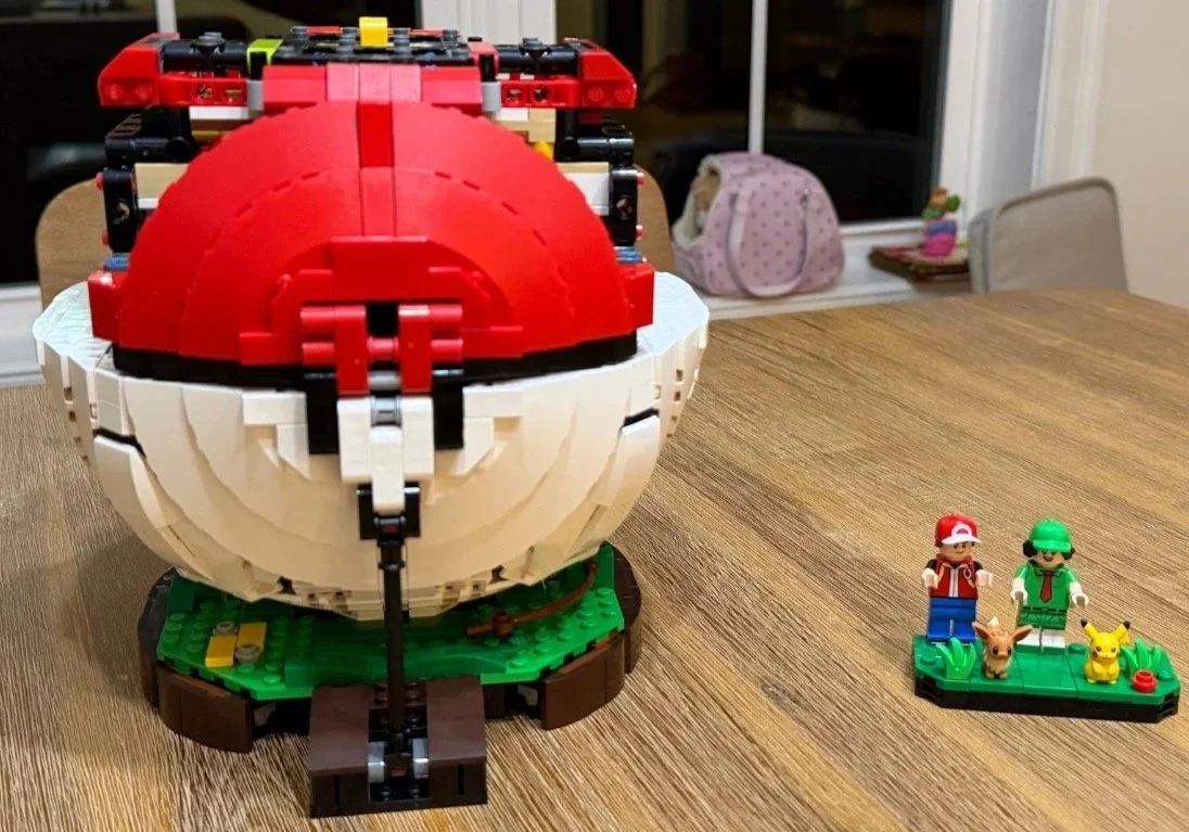 Rear structure and lever support beneath red upper panels on the LEGO Poké Ball.