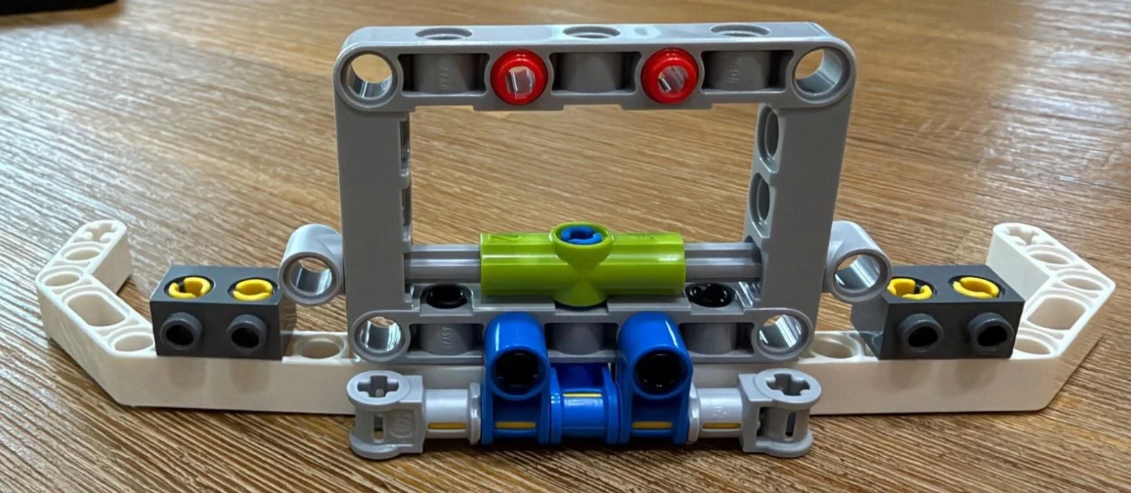 Square Technic frame with blue pins and internal connections during LEGO Poké Ball Bag 3.