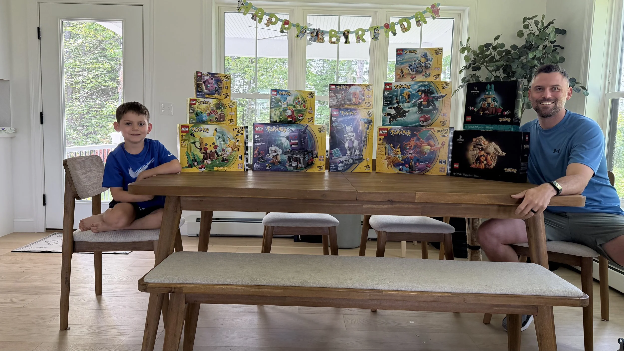 Josh McDougall and his son with a collection of LEGO® Pokémon sets.