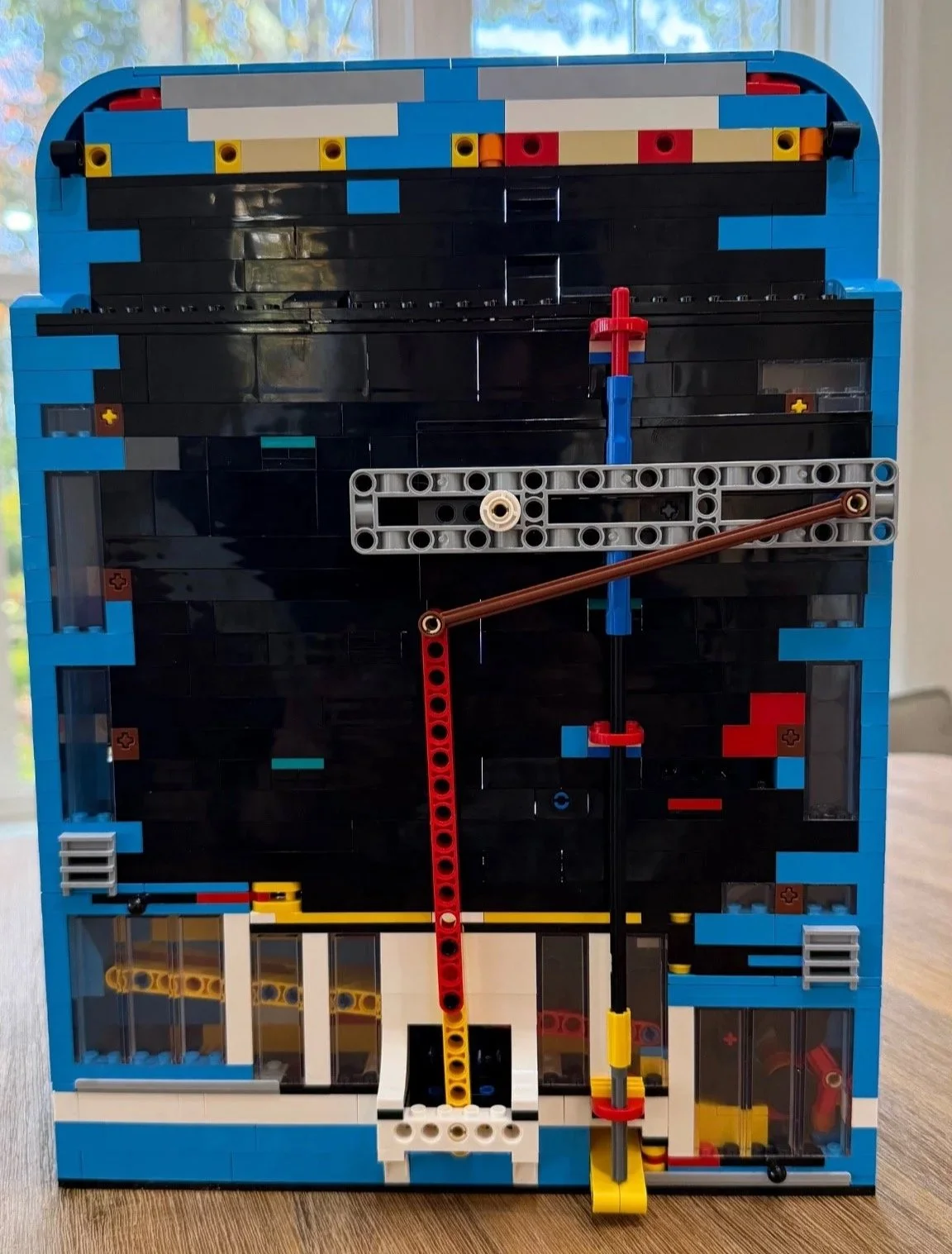 Rear of LEGO Donkey Kong Arcade 72051 showing the long red and brown linkage rods and gray horizontal mechanism.