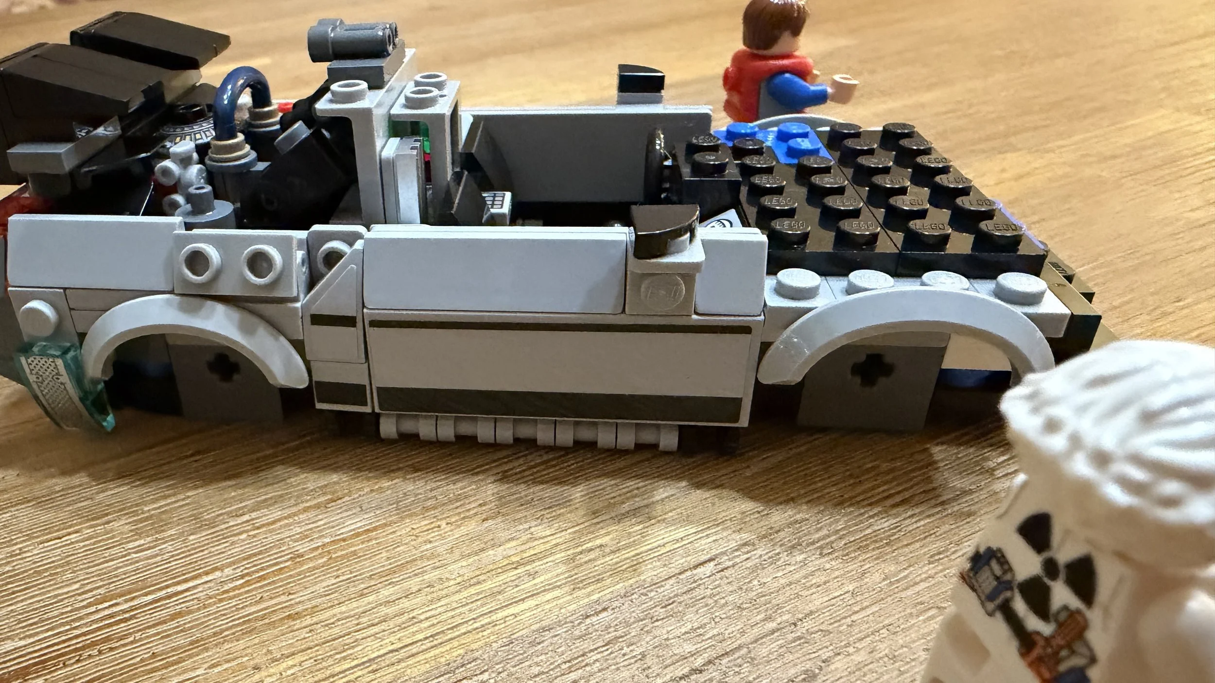 Close-up of the LEGO DeLorean door trim, side mirror, and wheel arches before the wheels and roof are fitted.