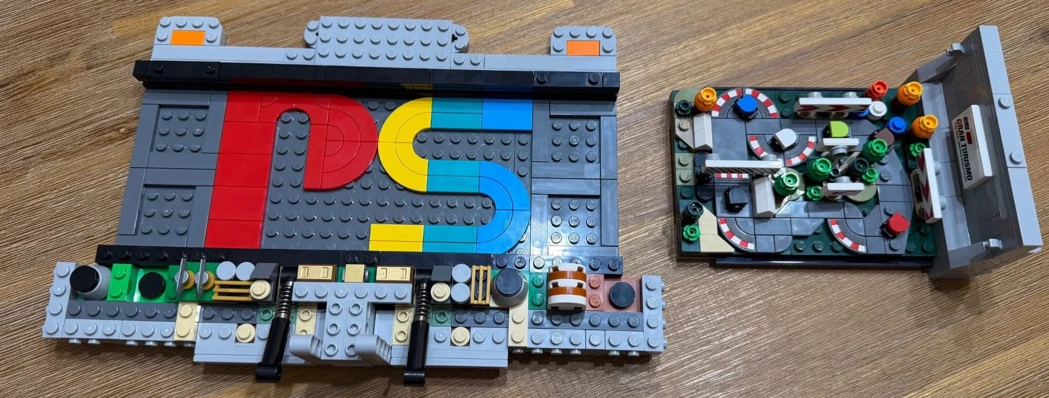 Early LEGO PlayStation base with internal component details, a developing Technic mechanism and the separate Gran Turismo scene.