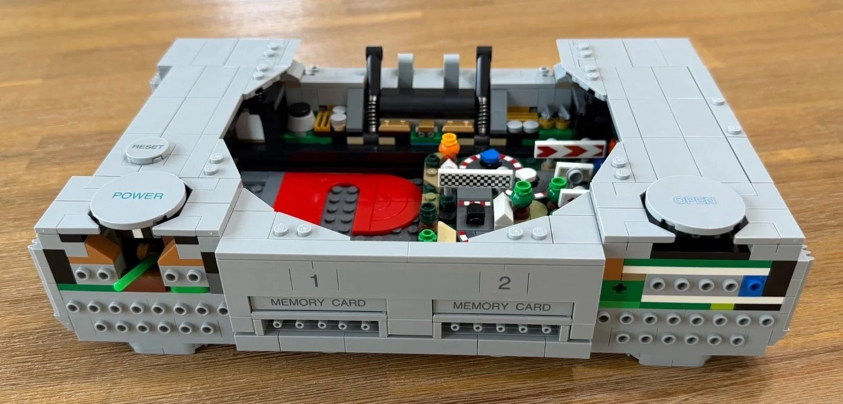 LEGO PlayStation top shell with printed button labels, vent details and the Gran Turismo scene fitted inside.
