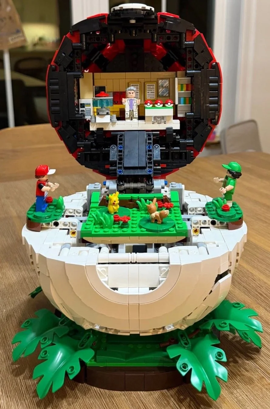 Completed LEGO Poké Ball open from the front, revealing Professor Oak’s laboratory, battle platform, and Pokémon figures.