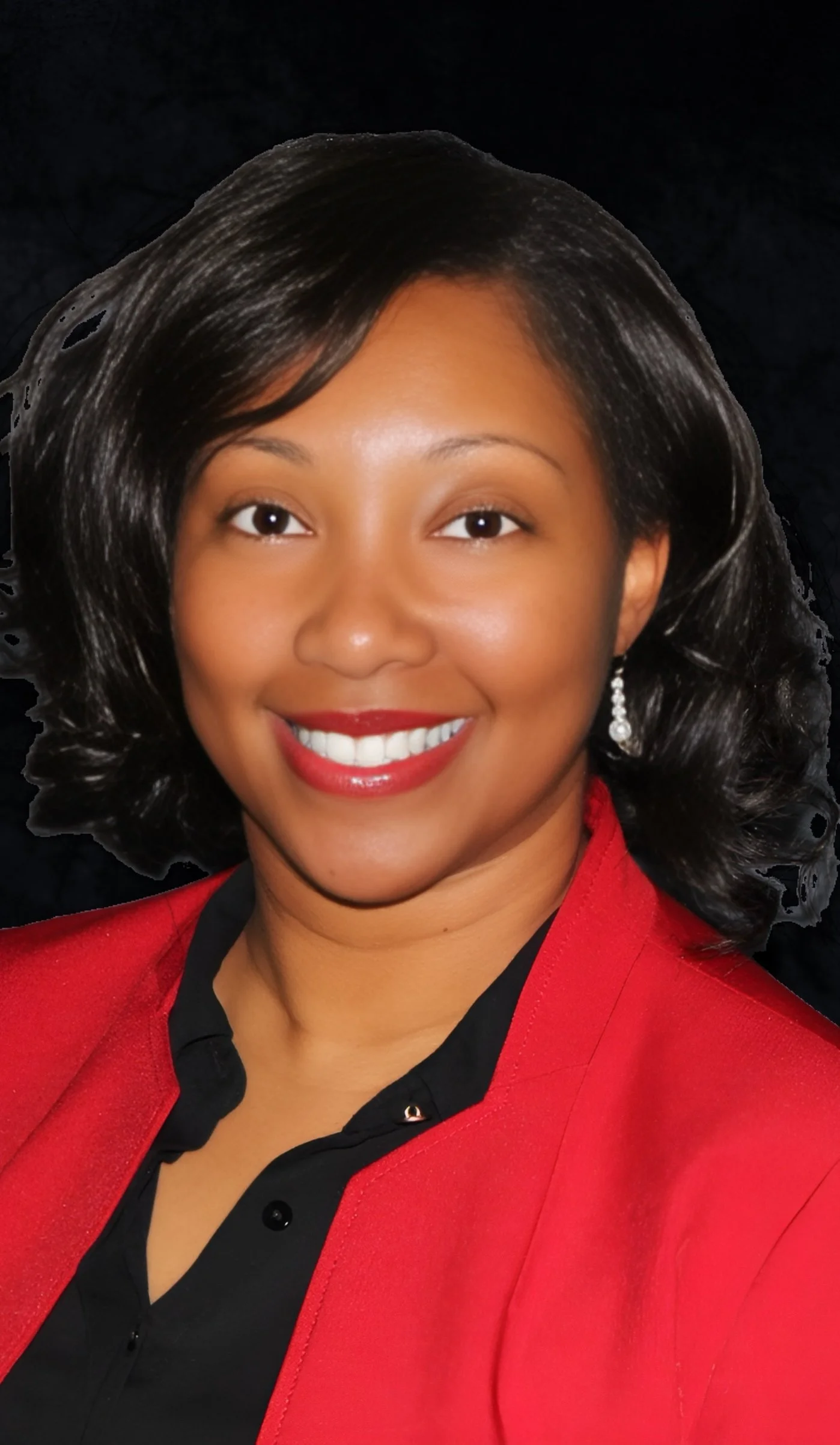 Professional portrait of a woman with shoulder-length black hair, smiling, wearing a red blazer, black blouse, and pearl earrings.