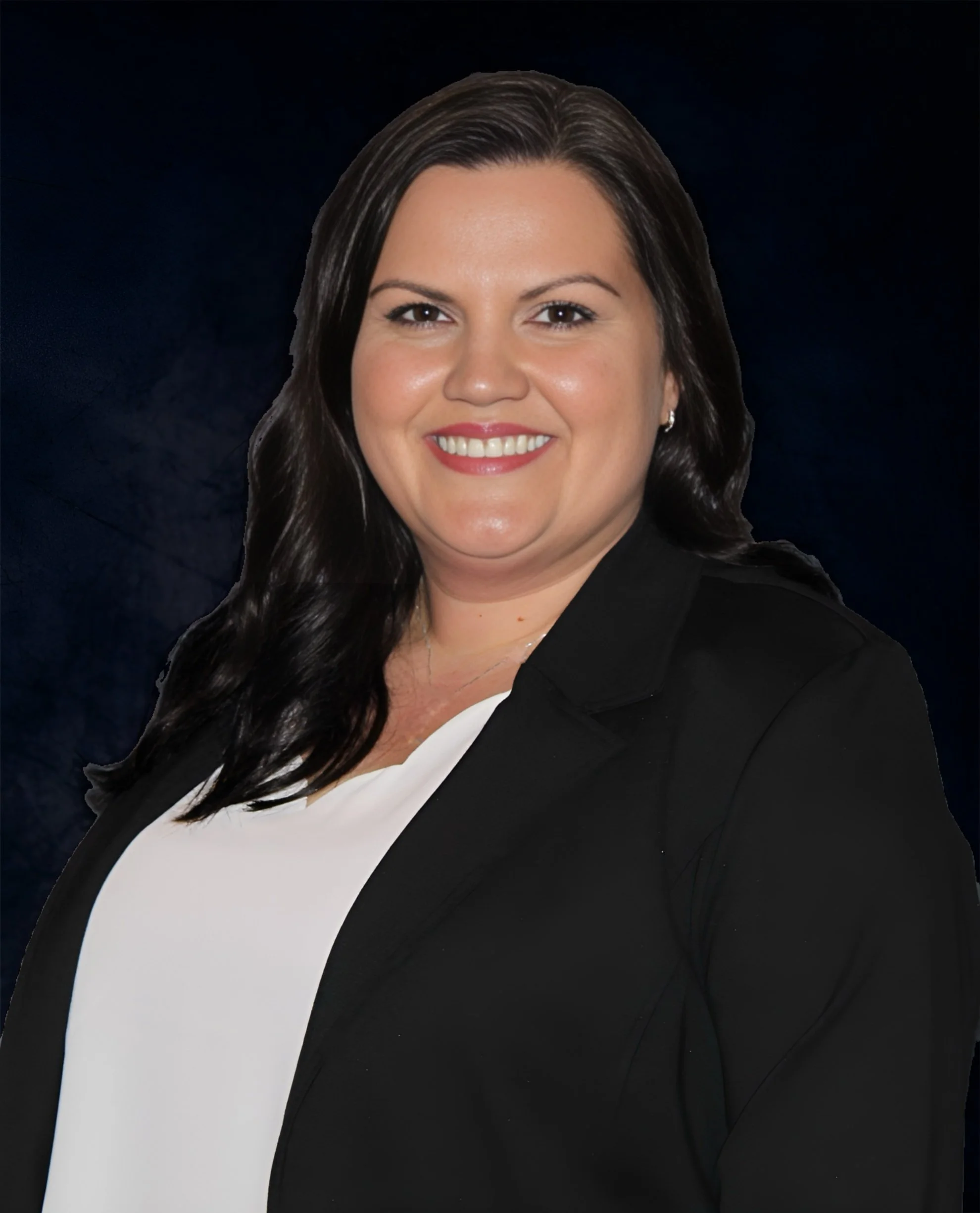 A professional woman with dark brown hair, wearing a black blazer over a white top, smiling against a dark background.