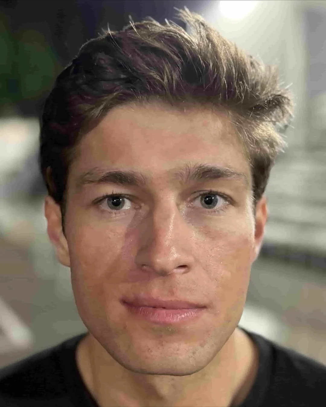 Close-up of a Sammy Aaron. He has short, dark, and slightly tousled hair, and light skin and is looking directly at the camera with a neutral expression.