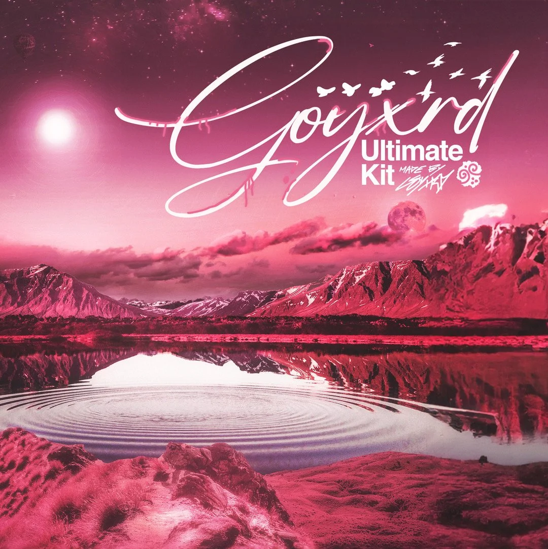 A young woman with curly purple and pink hair wearing sunglasses, a black graphic shirt with text 'SURF GANG AT LEAST WE TIED', and black pants, standing outdoors near a chain-link fence on a sunny day with a grassy field and hills in the background.