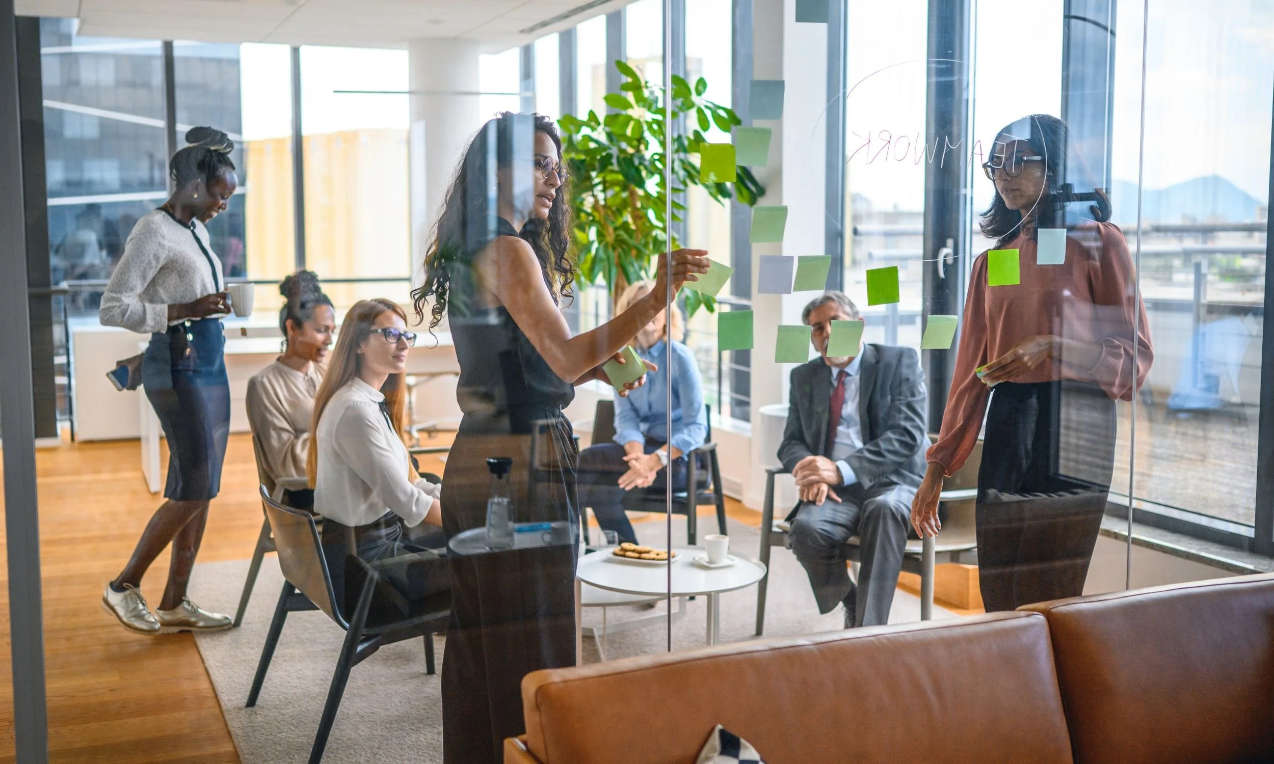 Shows a female entrepreneur leading her team