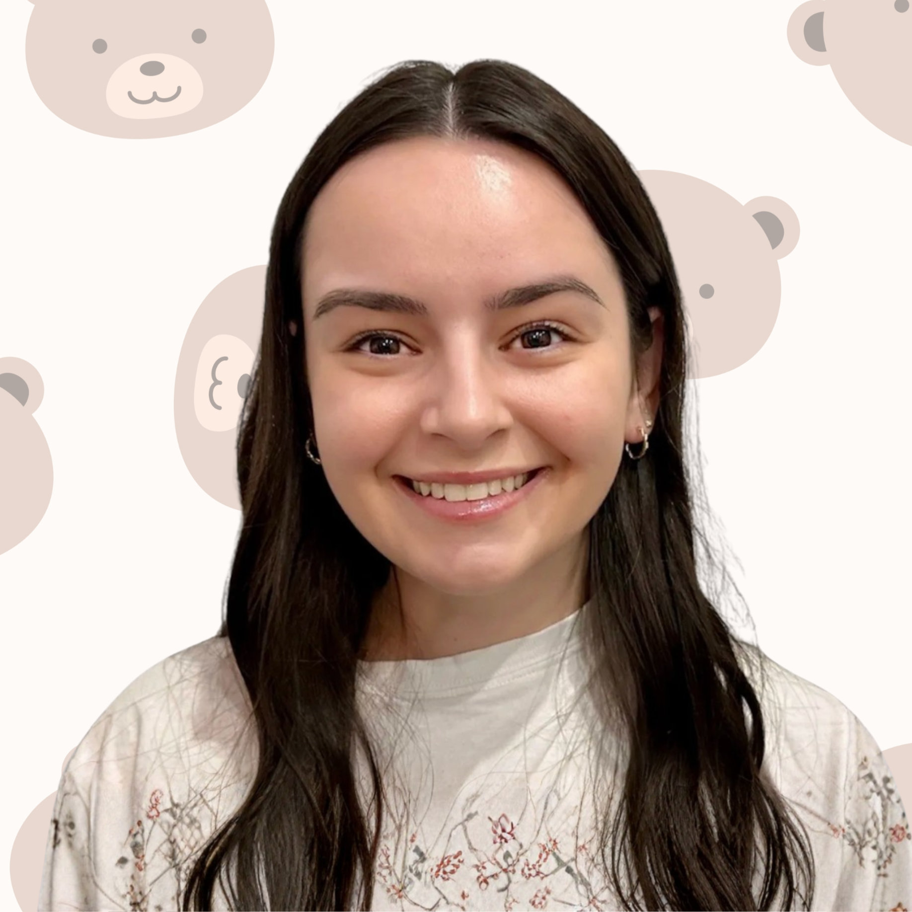 A young woman with long dark hair, smiling, wearing a white top with floral embroidery, and silver hoop earrings, in front of a background with bear face illustrations.
