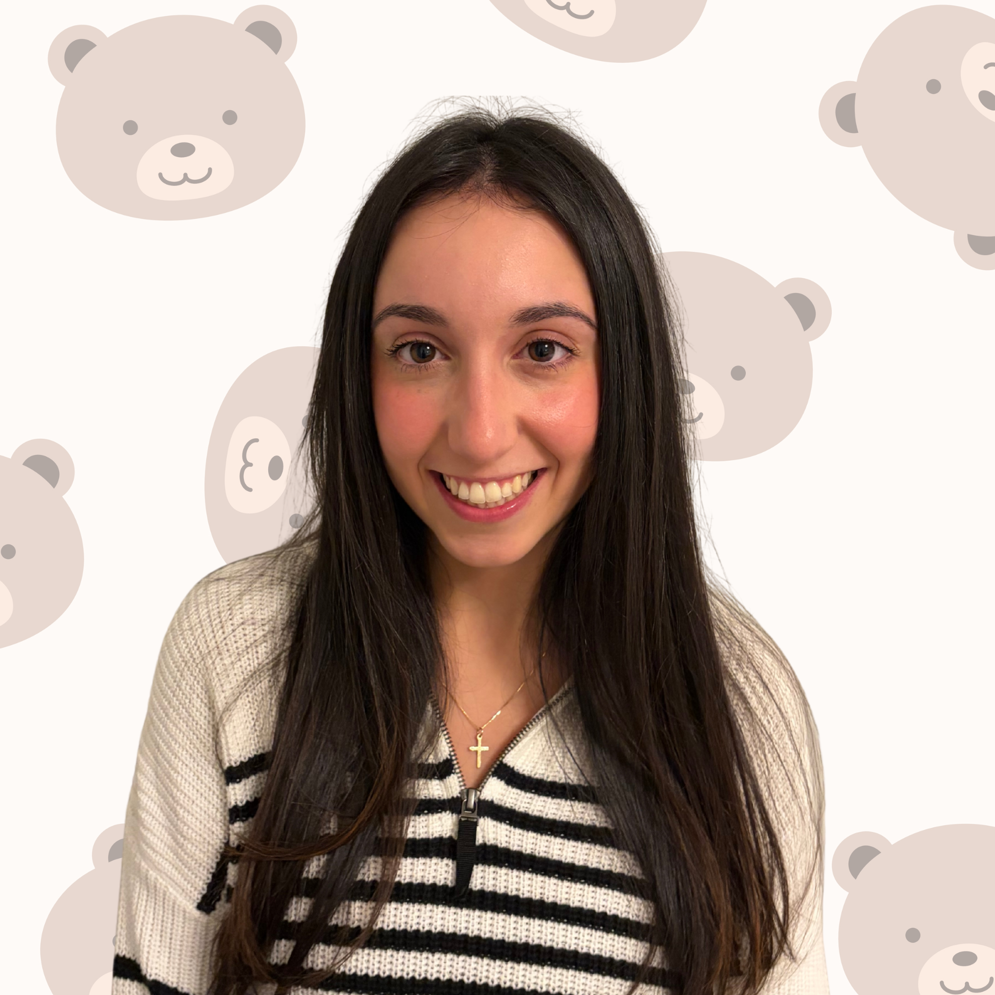 A woman with long dark hair smiling, wearing a white and black striped sweater with a zippered neckline and a gold cross necklace, against a background with cute bear faces.