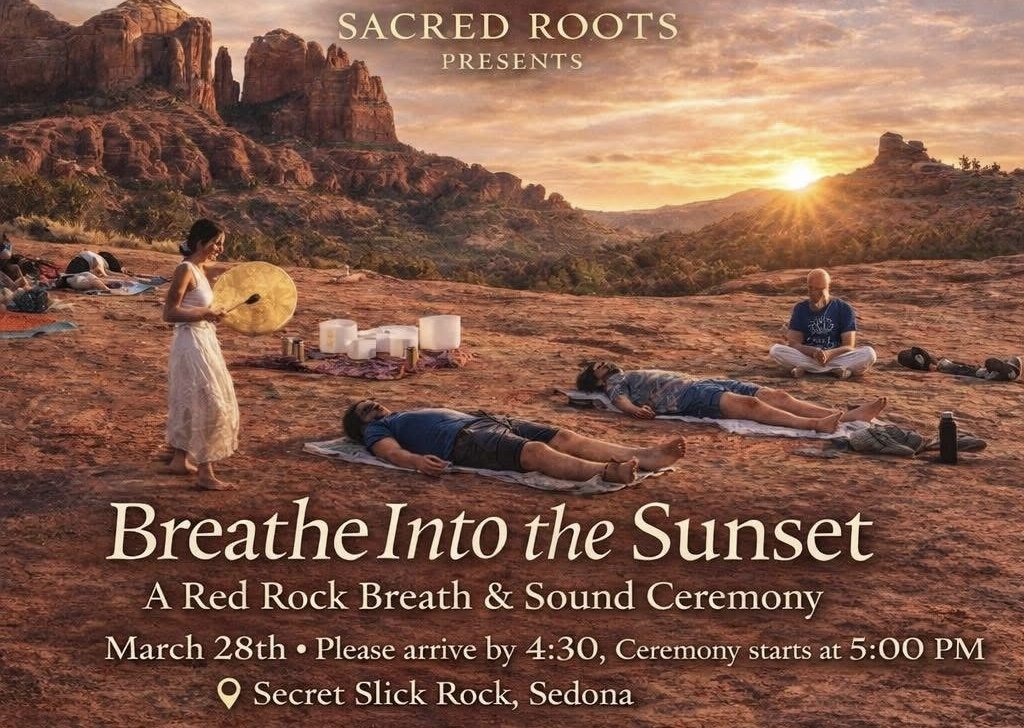 A group of people participating in a sunset yoga or meditation session on a rocky landscape with mountains in the background. The sky is orange and pink, and the sun is setting. Some individuals are lying on mats, and there is a person holding a large gong.