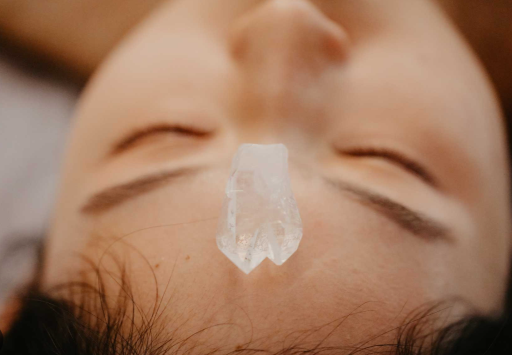 Close-up of a person's face with closed eyes and a piece of adhesive tape on their nose.