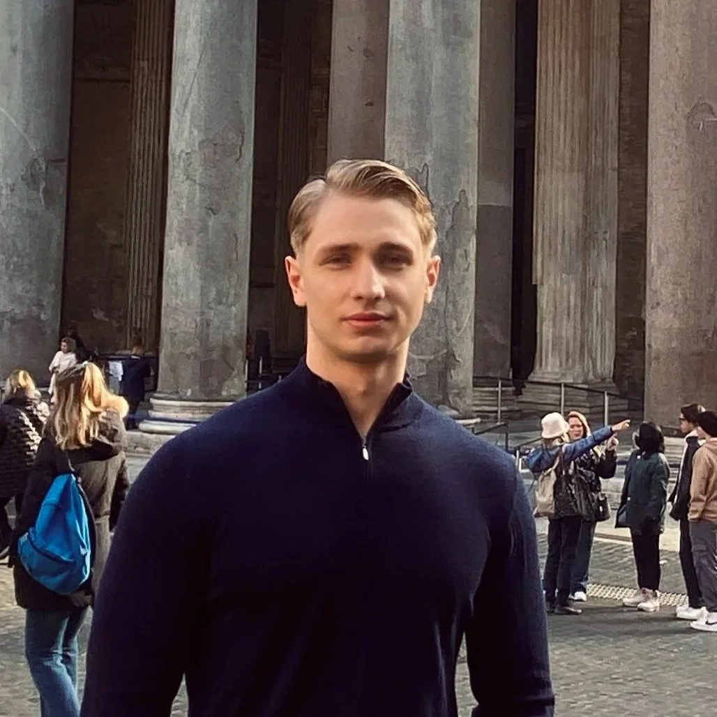 A portrait of Luke Kosonen in a blue quarter zip.