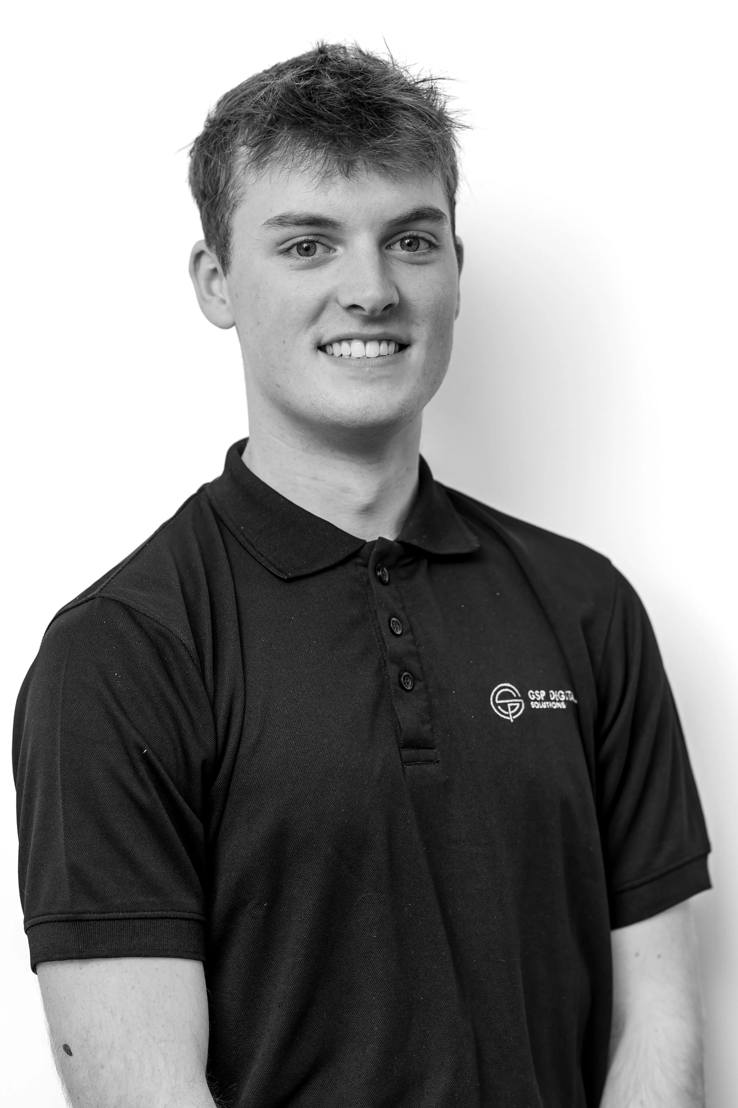 GSP Digital Solutions team member in branded hoodie standing against a neutral background.