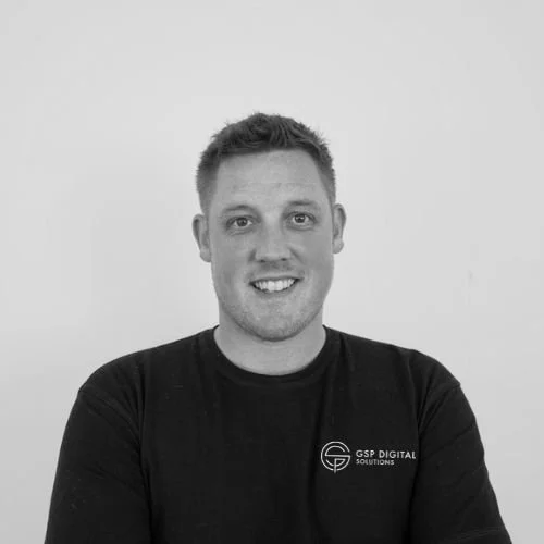 Team member at GSP Digital Solutions smiling in a black and white portrait.