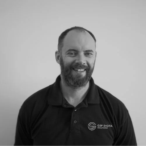 Team member at GSP Digital Solutions smiling in a black and white portrait.